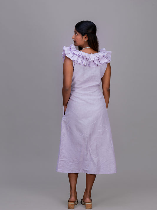 A woman shown from the back wearing a sleeveless Cherry Pink dress with a ruffled off-the-shoulder neckline, side pockets, and a midi length, paired with brown platform sandals against a solid gray studio background.