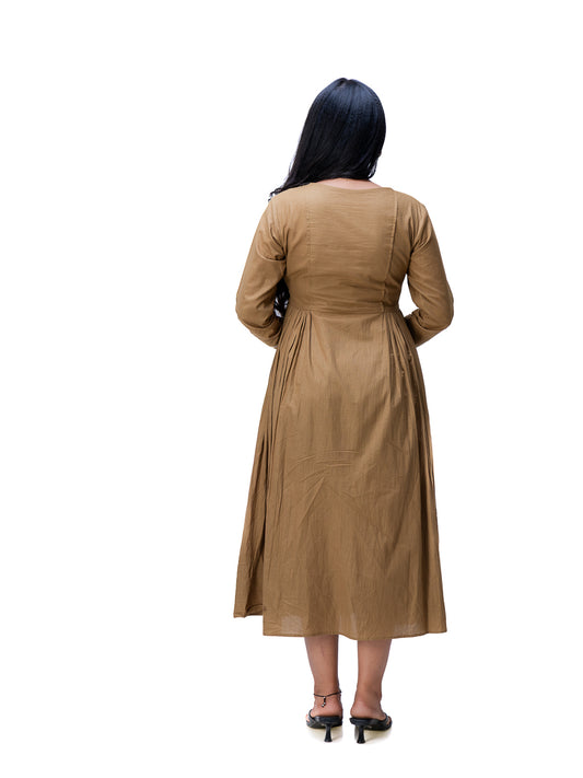 A woman viewed from behind wearing a long-sleeved Oak Brown midi dress with a gathered waist, paired with black heels, isolated on a white background.
