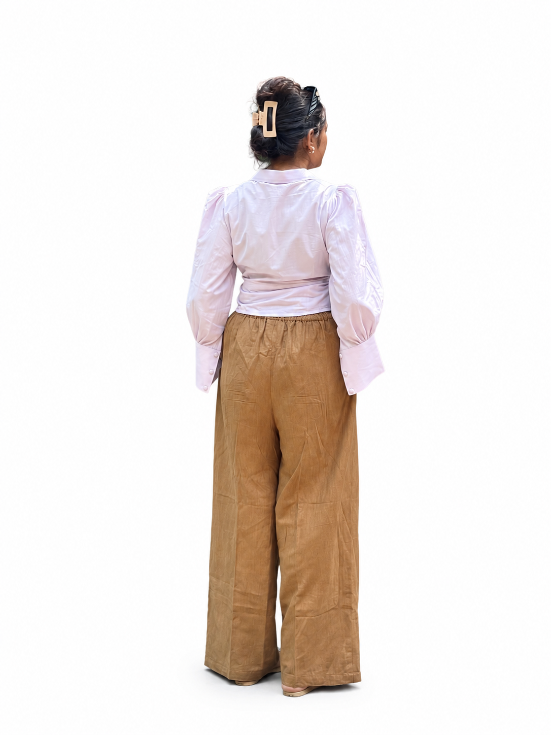 A woman shown from the back wearing a Ash pink long-sleeve blouse and wide-leg tan pants, standing against a plain background.